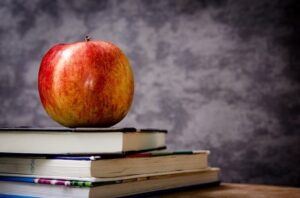 apple and stack of books